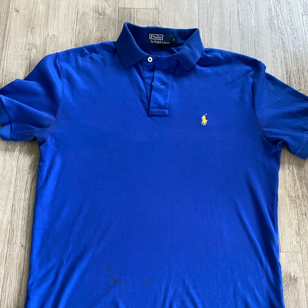 Polo by Ralph Lauren blue. Shirt has some stains. Shown on one of the pictures